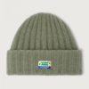 American Vintage Vitow muts VITO22AH26KAKMUL in Kaki Multichiné, groen gemêleerde fluffy gebreide muts met omgeslagen rand en American Vintage logolabel.